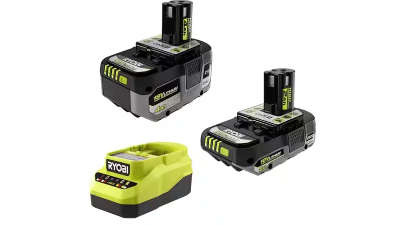 A stock image of two Ryobi batteries and a charger.