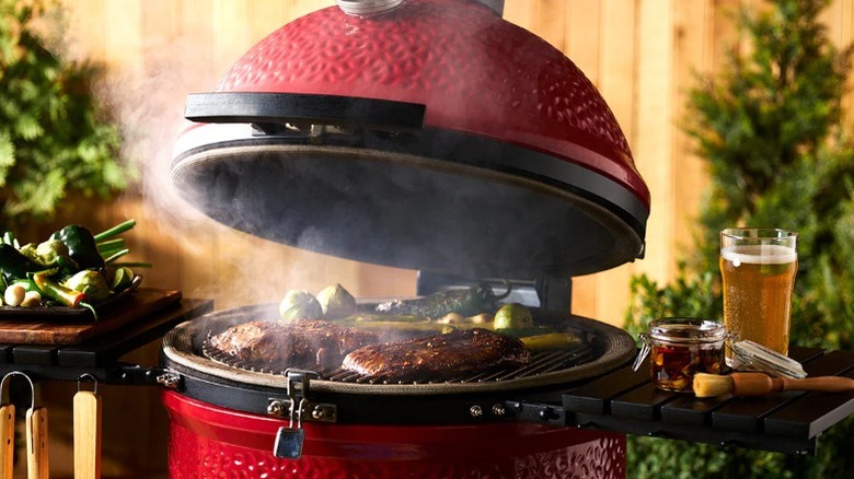 Kamado Joe Classic Joe II grilling food with hood open