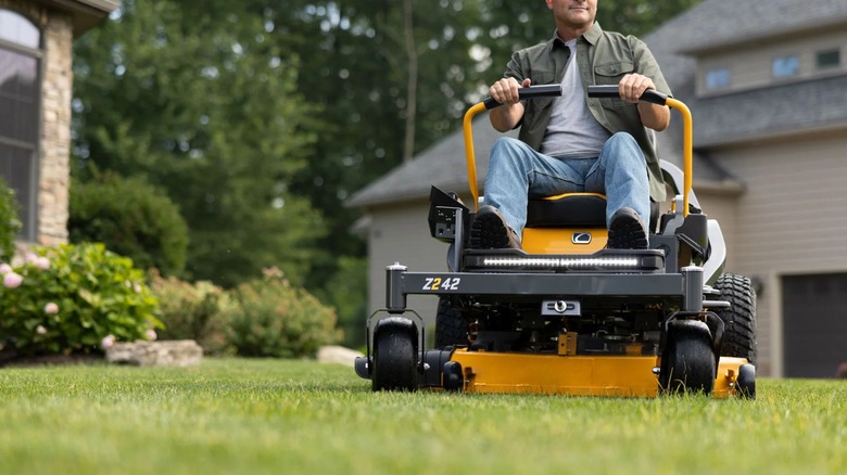 Landscaper mowing lawn with Cub Cadet zero-turn mower