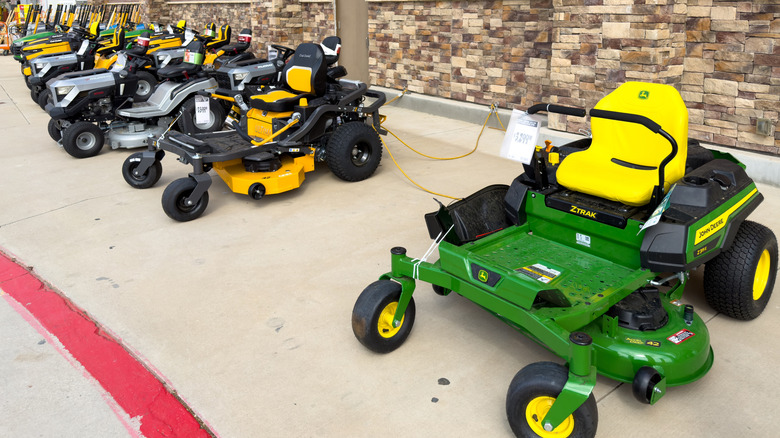 Zero-turn mowers on display outside a Home Depot store