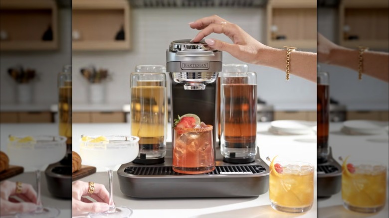 person pressing bartesian cocktail mixer