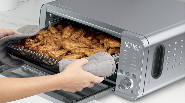 person taking chicken out of Ninja Flip