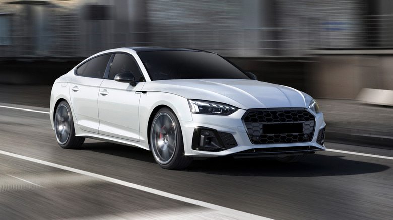 White Sports car speeding on street road