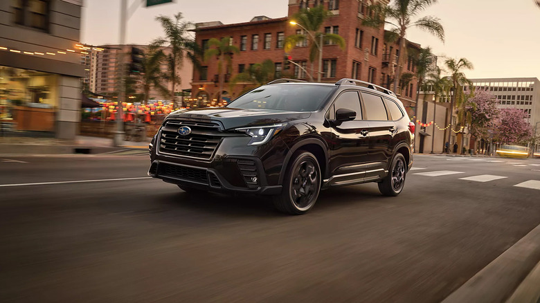 A black 2025 Subaru Ascent driving through a city