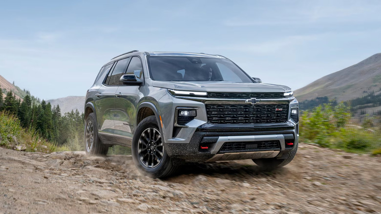 A gray 2025 Chevrolet Traverse driving off-road
