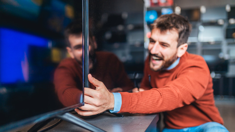 Man lifting a TV