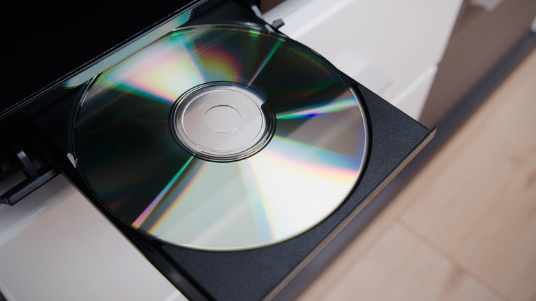 Close-up of an open Blu-ray player disc tray holding a blank silver disc