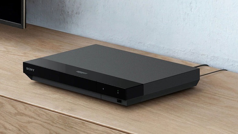 Sony UBP-X700U Blu-ray player on a wooden shelf