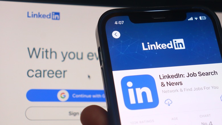 Person holding up a phone with LinkedIn