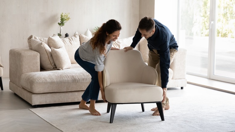 couple moving a chair
