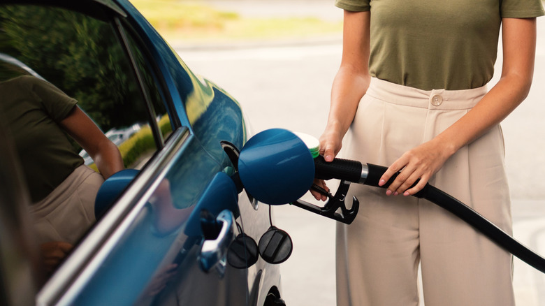 Woman Refilling Auto with Bio Fuel at Modern Petrol Station