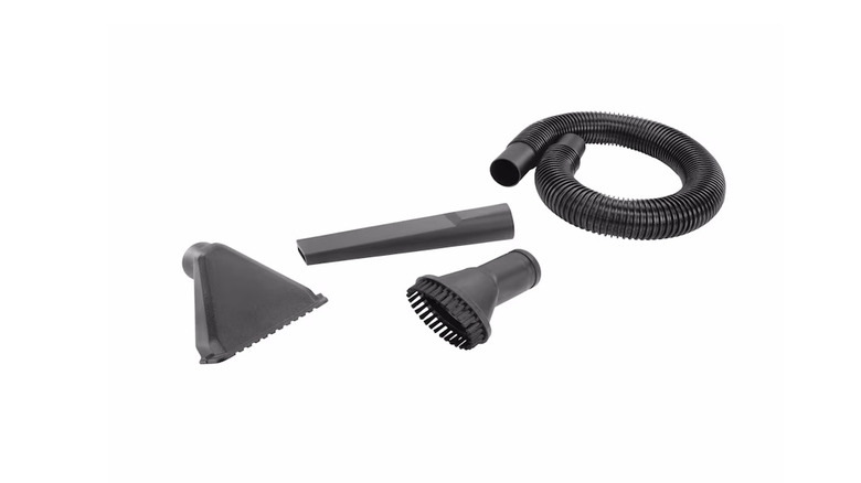 A hand vacuum dust brush, a hose, an extension wand, and an upholstery brush on a white background.