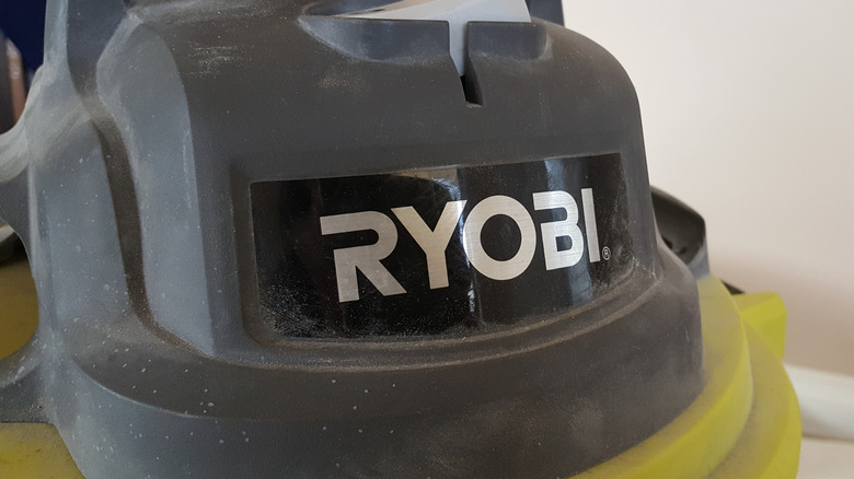 A close-up of a shop vacuum with the Ryobi logo on it.