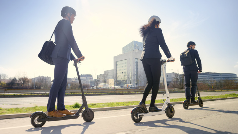 three commuters using electric scooters