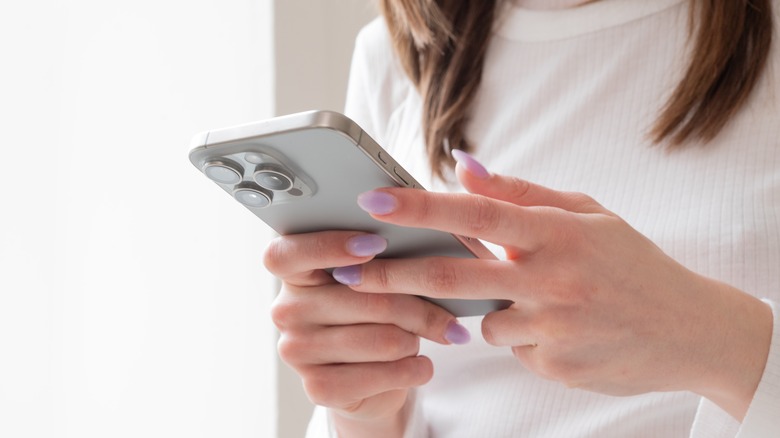 woman using iphone 15