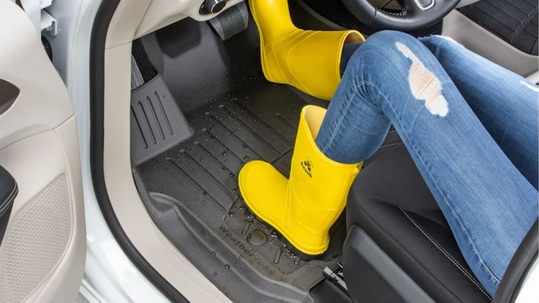 Rain boots on a wet WeatherTech car floor mat