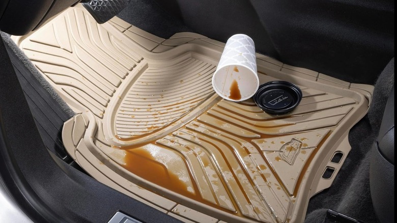 Beige Armor All car floor mat with spilled coffee cup