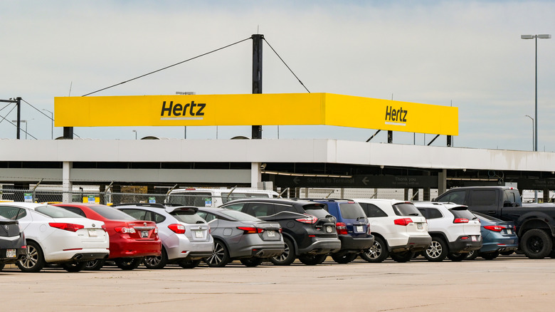 A Hertz rental location with a range of cars