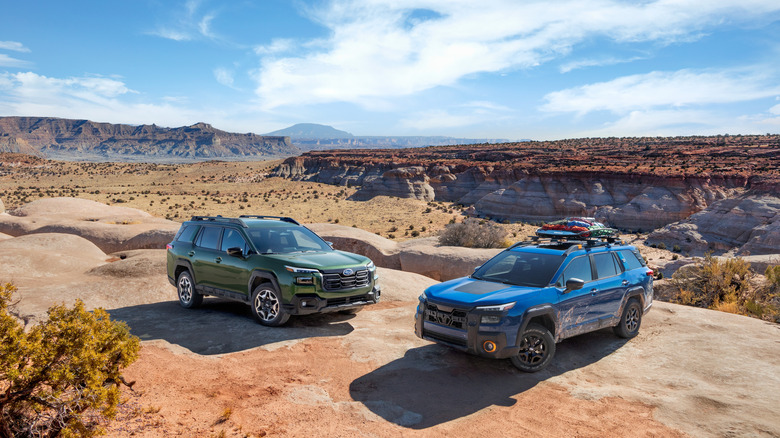 Left: 2026 Subaru Outback and right: Subaru Outback Wilderness, front-right and front-left 3/4 views, photographed in desert terrain