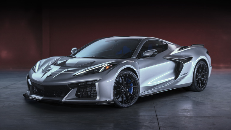 2026 Chevrolet Corvette ZR1X on dark red and gray background, front-left 3/4 view