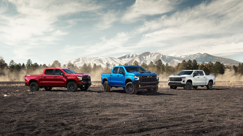 Three 2025 Chevrolet Silverado trucks parked