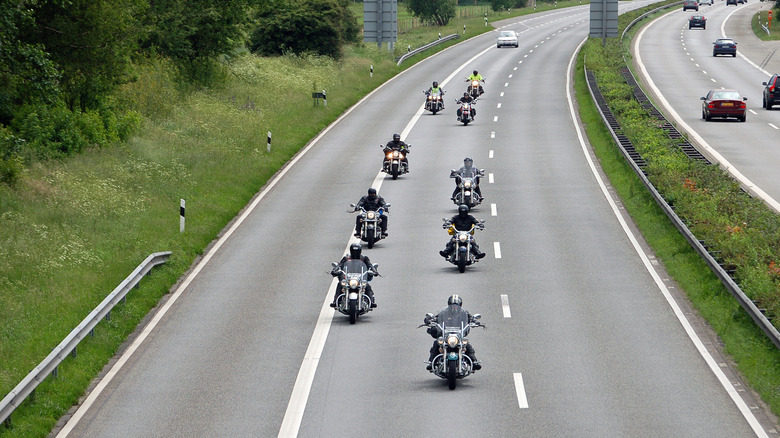 A group of bikers riding along a highway