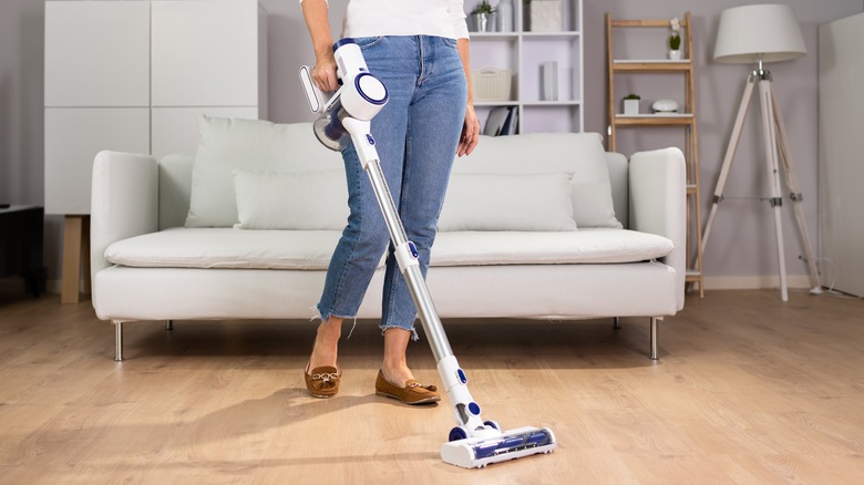 Woman using cordless vacuum