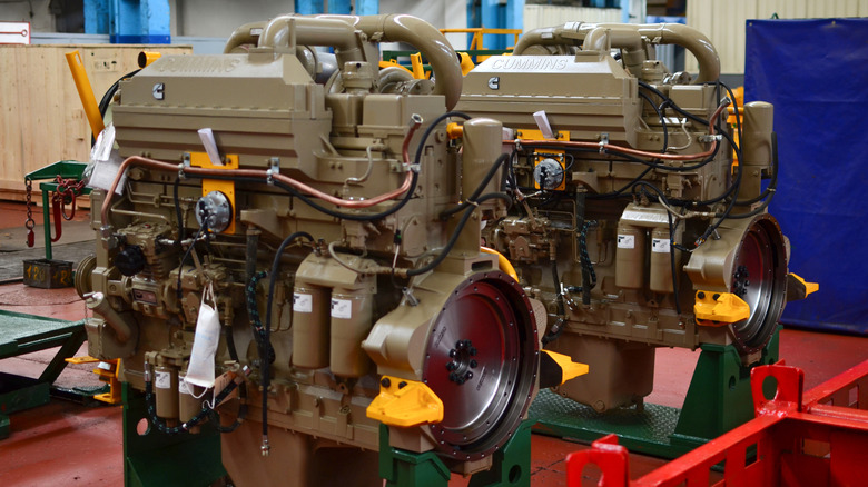 A Cummins engine on an engine mount, painted beige