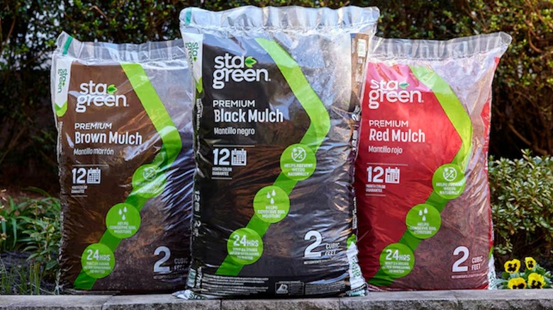Three bags of brown, black, and red Sta-Green Premium Mulch