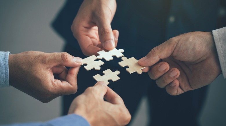 people sharing puzzle pieces