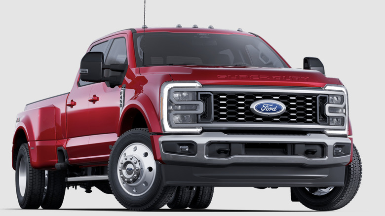 Red Ford F-450 Super Duty Lariat dually truck on white background
