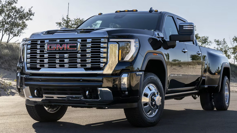 A black GMC Denali HD dually truck parked on the road