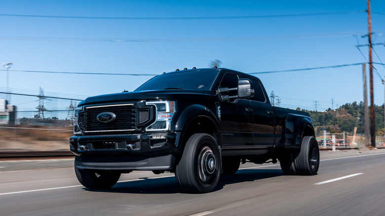 A black Ford F-450 on the highway