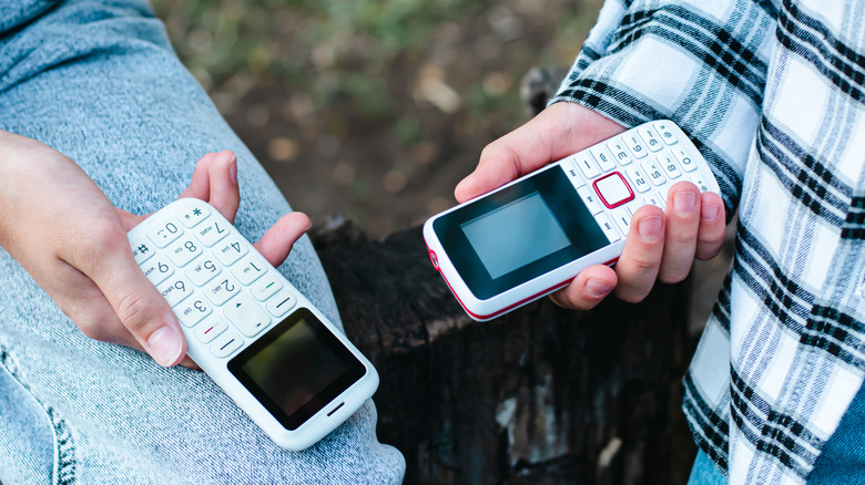 People holding two cell phones