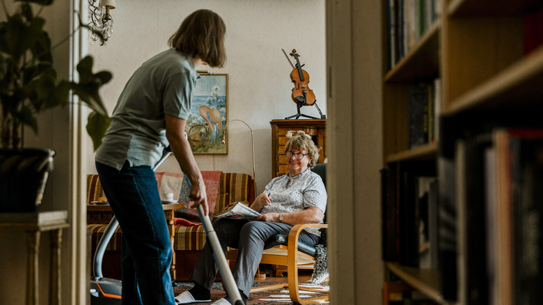 Person chatting and vacuuming