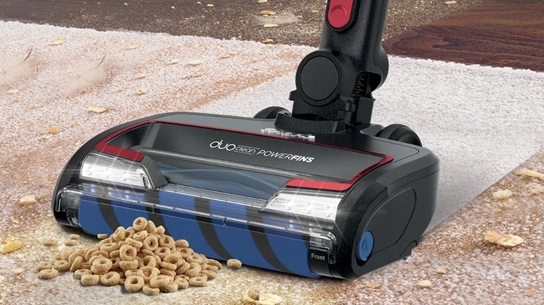 Close up of Shark Vertex Pro cleaning Cheerios from carpet