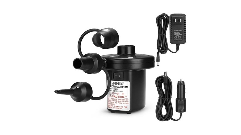 The AGPTEK electric air pump next to two adaptors.