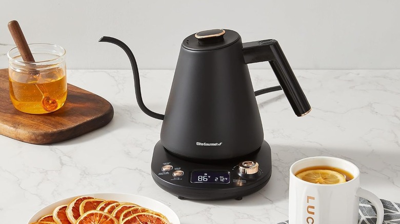 Elite Gourmet gooseneck kettle next to a pot of honey