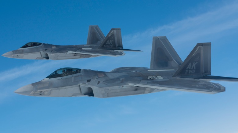Two F-22 Raptors flying in close formation