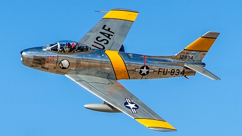 A restored F-86 Sabre flying over blue skies