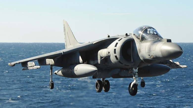 An AV-8B Harrier II making a vertical landing on the ITS Cavour
