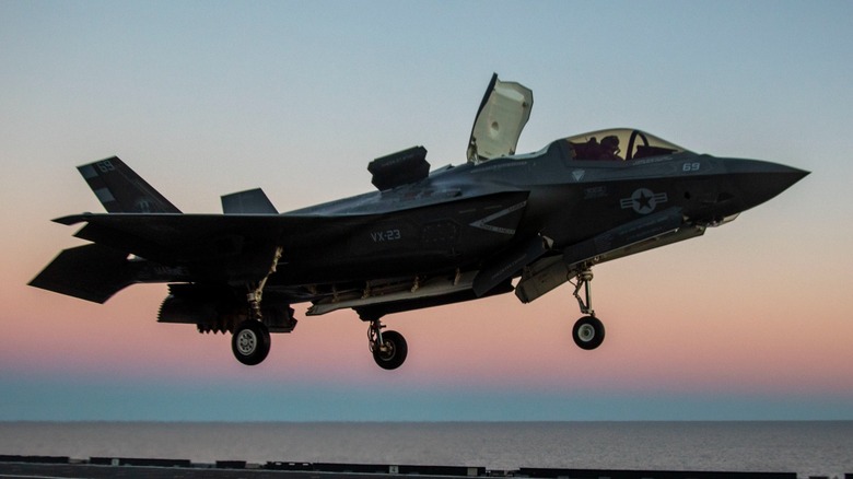 A USMC F-35B Lightning II performing a vertical landing on the ITS Cavour