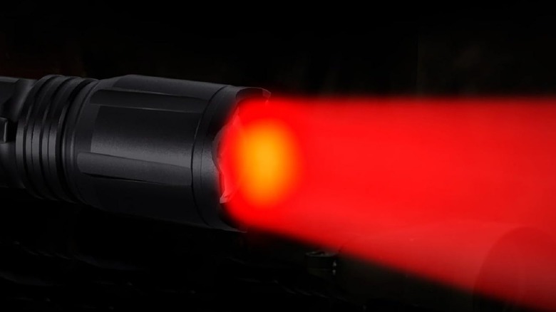 The Lumenshooter Zoomable Color Flashlight beaming a red light.