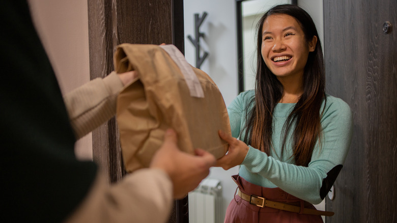 woman accepting food delivery