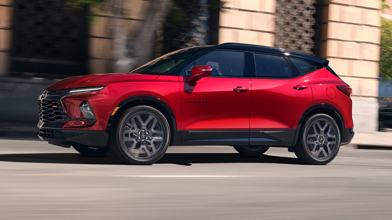 A red 2025 Chevrolet Blazer driving