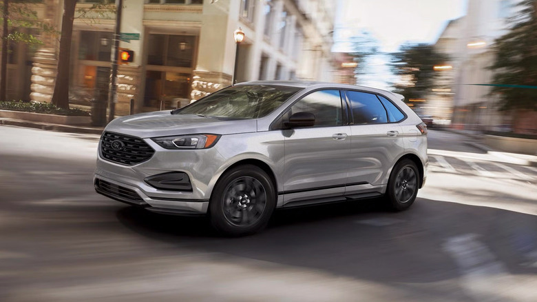 A silver 2024 Ford Edge driving