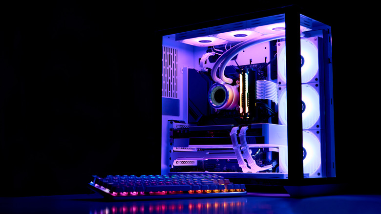 An image of a gaming PC boldly featuring RGB lighting with a keybard, both in front of a dark background