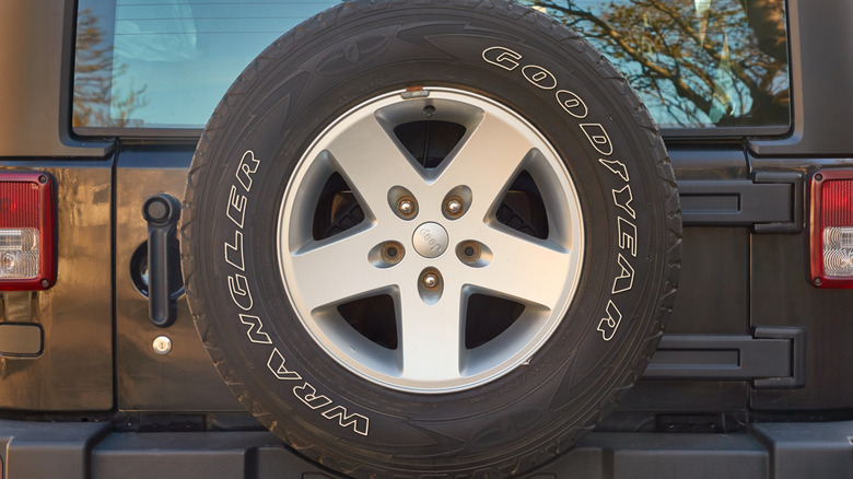 A close-up of a Jeep Wrangler's rear-mounted spare Goodyear Wrangler Tire.