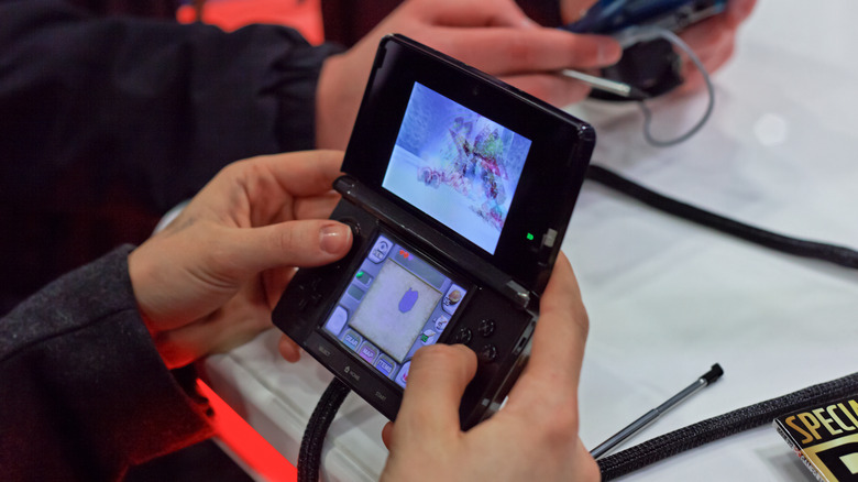A Nintendo 3DS being used with its 3D technology at an event