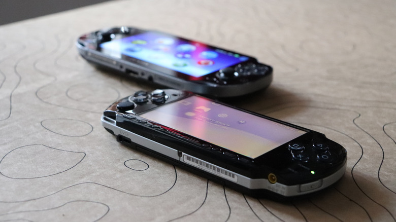 A PSP and PSP Vita on display on a table